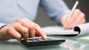 man using calculator to take a test